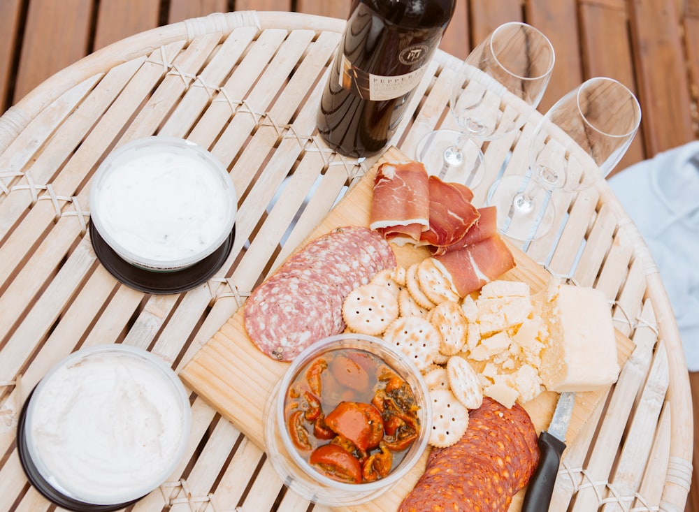 meats and biscuits on tray beside glasses