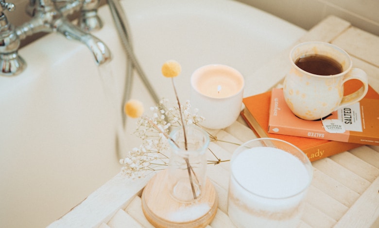 a cup of coffee and some books on a bathtub