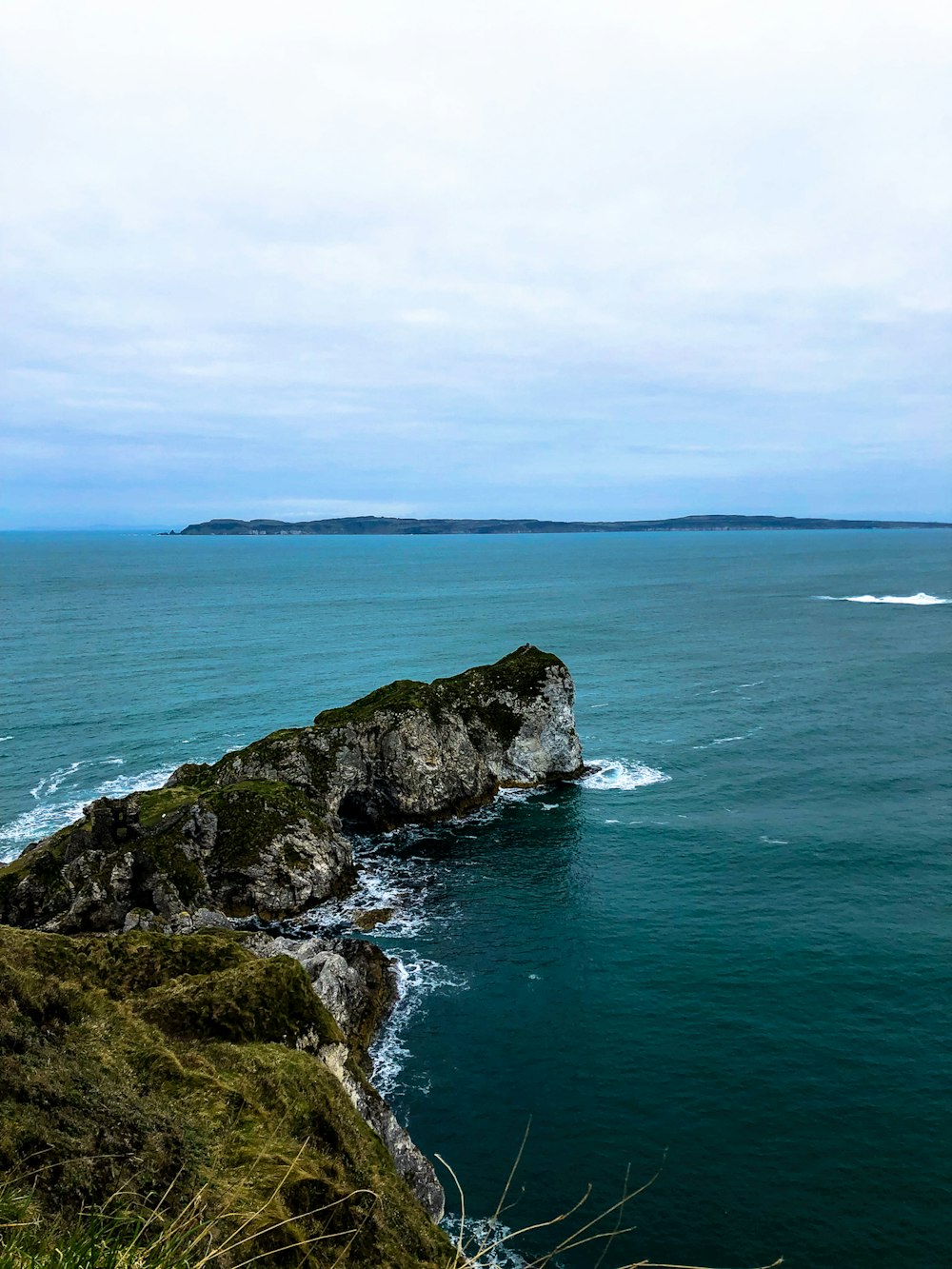 gray rock formation on water