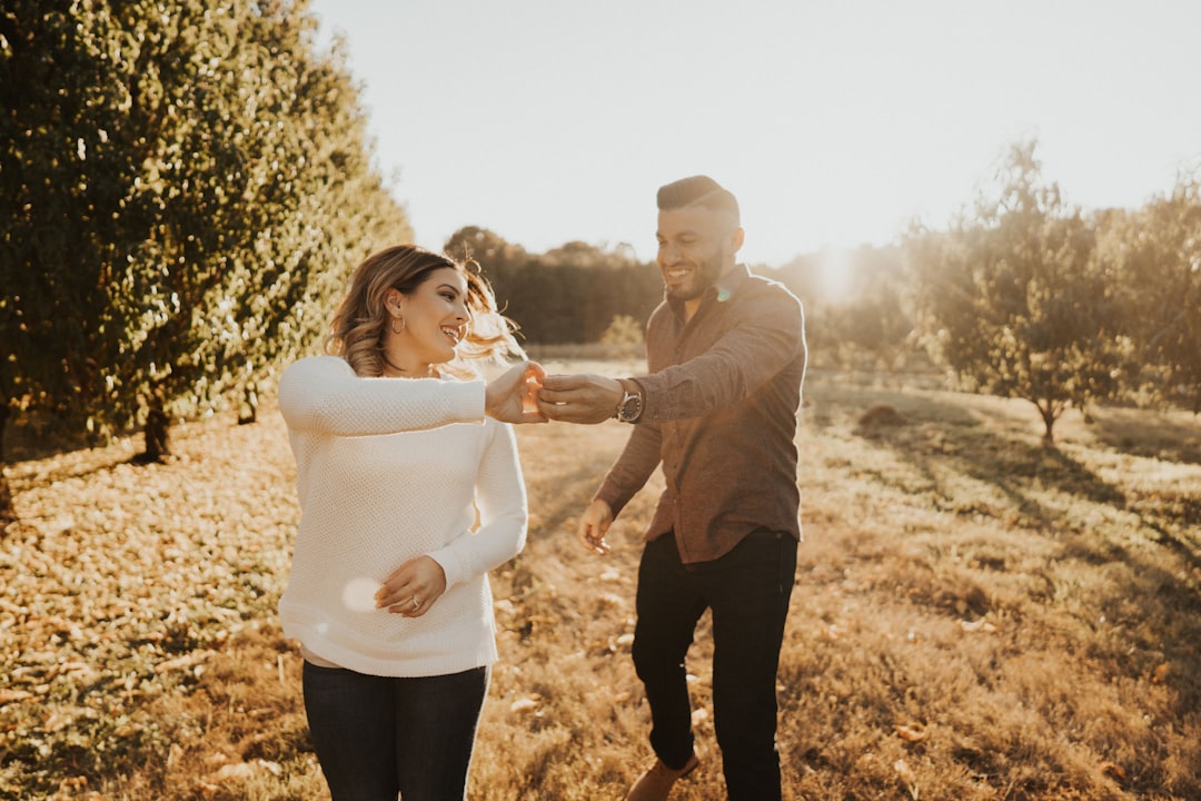 woman holding hands with man during daytime