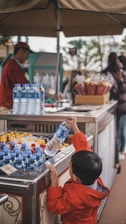 boy holding blue plastic bottle