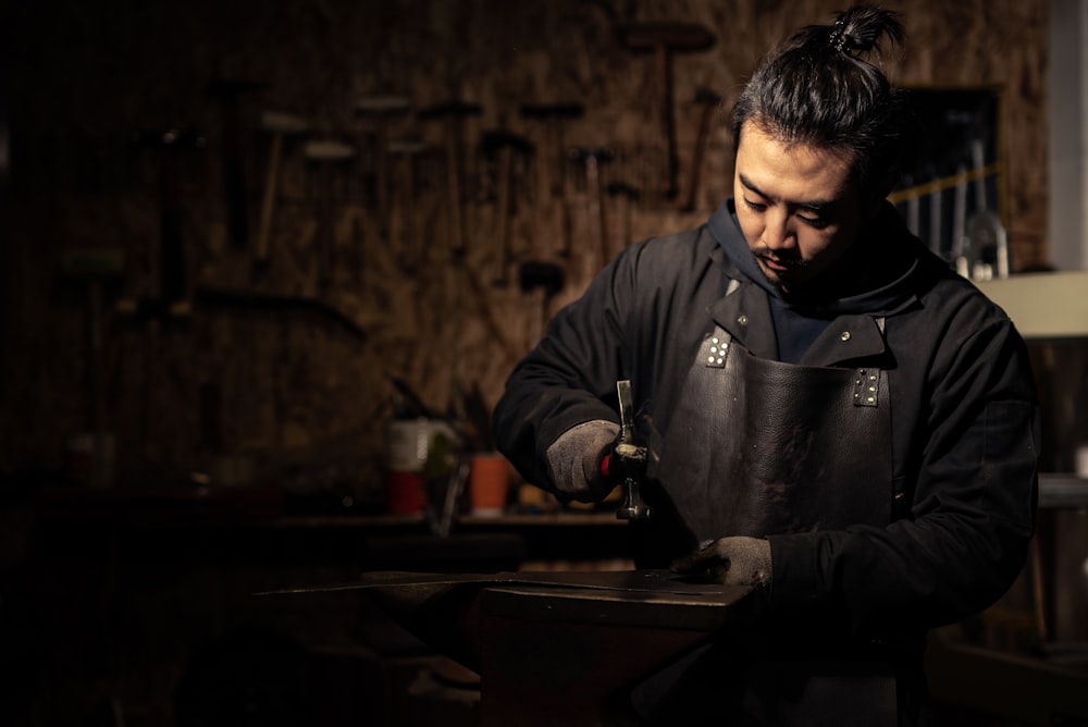 man standing and using hammer