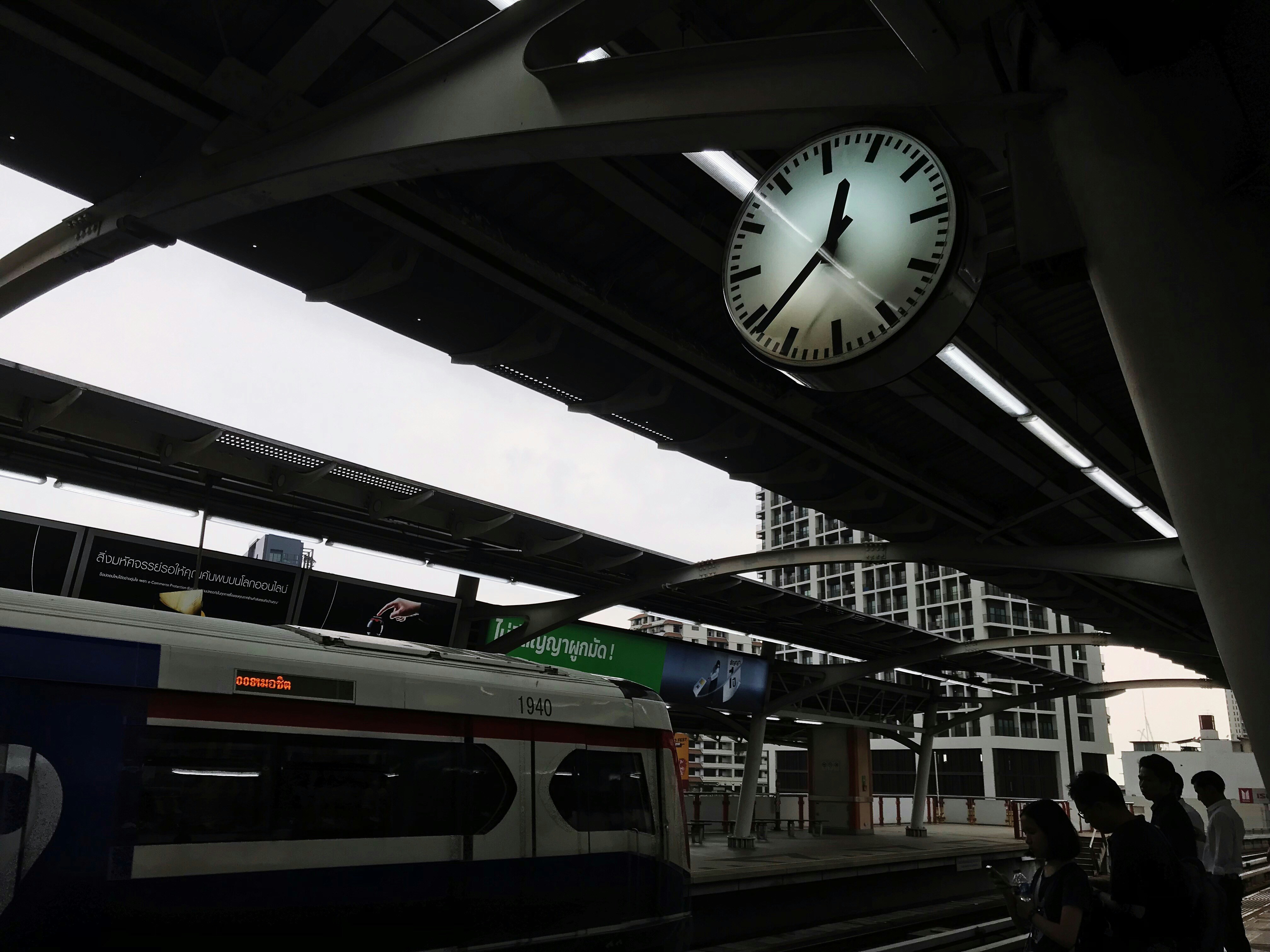 people on train terminal in silhouette photography, 