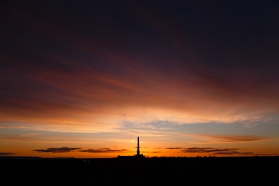 An elegant launch pad with a rocket poised against a twilight sky.