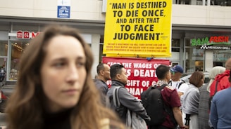 a group of people standing in front of a building holding up signs with Bible scriptures