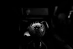 black vehicle gear shift lever in grayscale photography