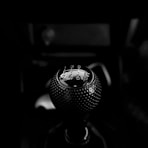 black vehicle gear shift lever in grayscale photography