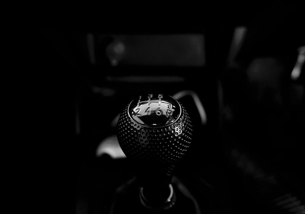 black vehicle gear shift lever in grayscale photography
