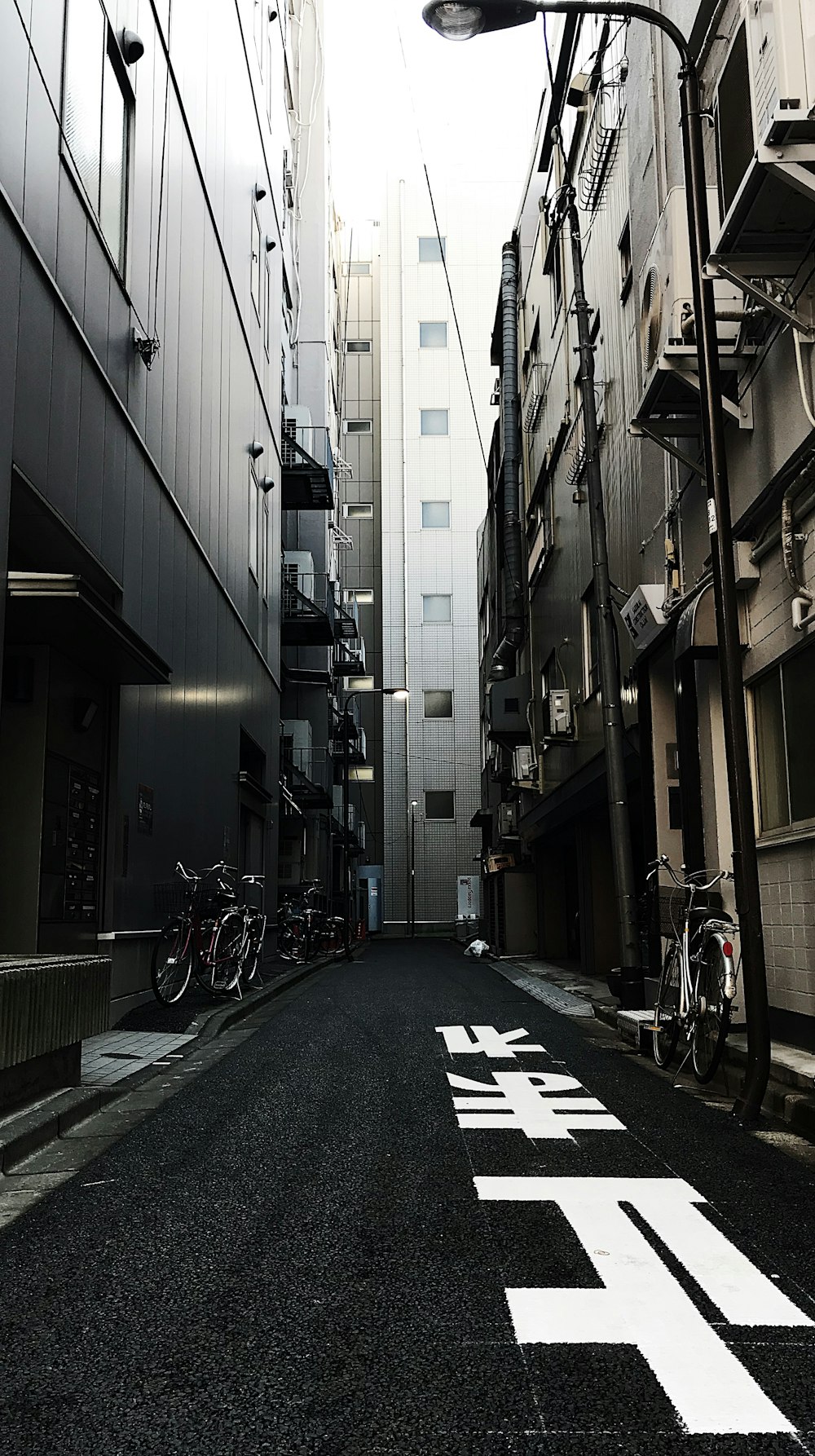 alleyway with parked bikes during daytime