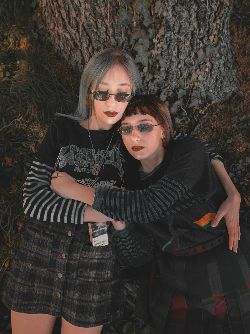two woman wearing black-and-gray striped long-sleeved shirts