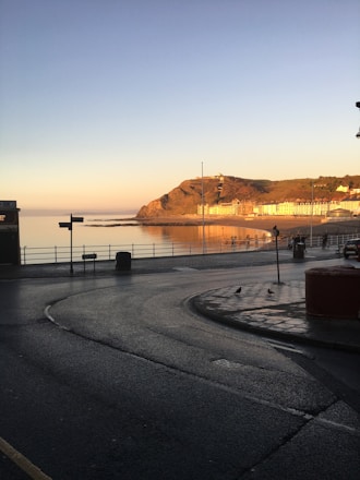 A traveler consulting a map near Qingdao’s iconic seaside promenade at sunset.