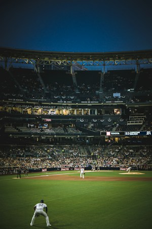 A crowd of baseball fans gathered in the stands at a stadium