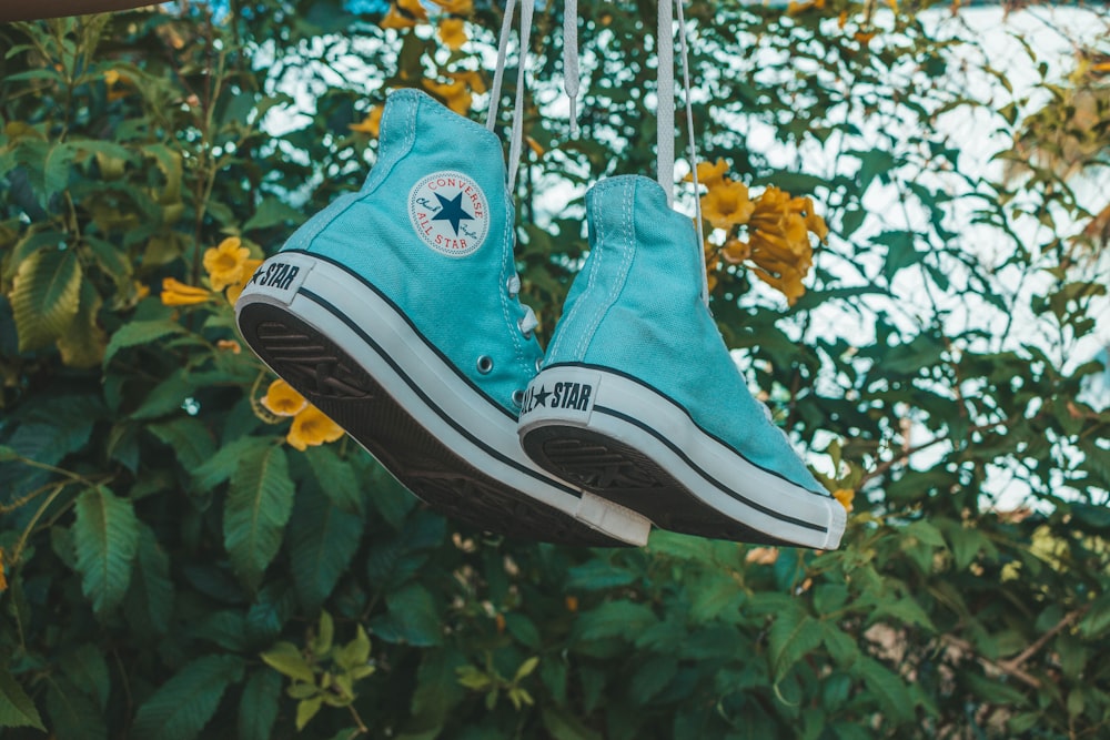 pair of teal Converse hightops hanging