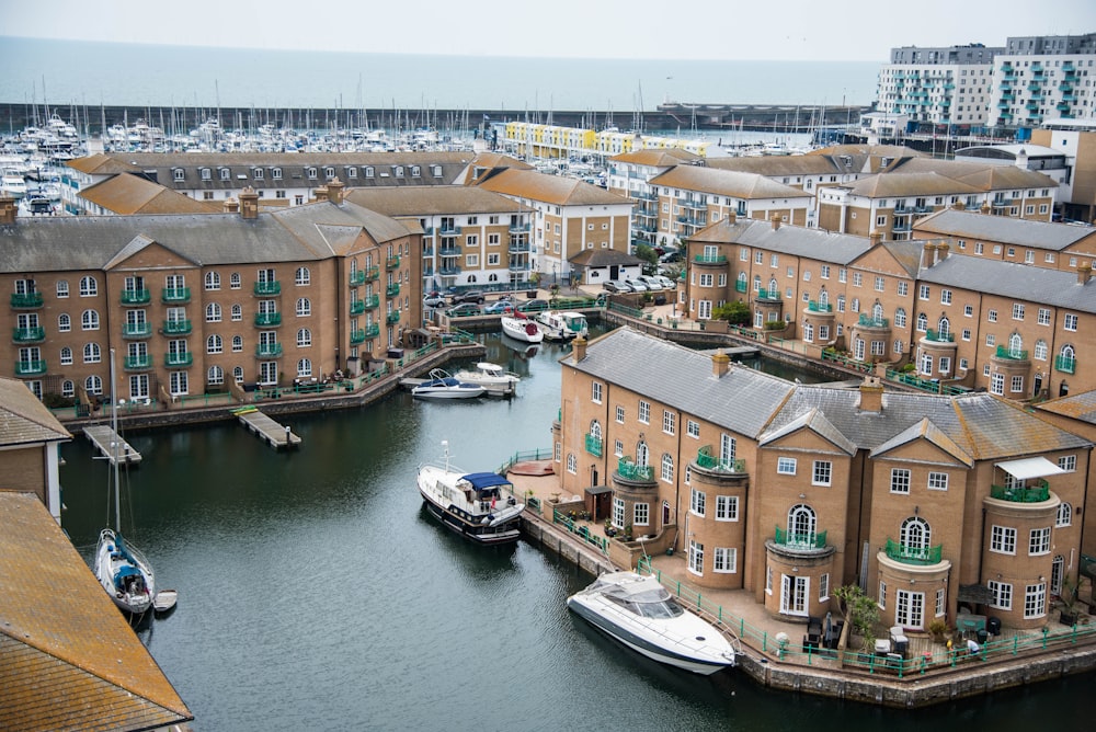 white boats docked in front of buildings