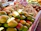 Close-up of ripe mangoes stacked neatly at a market stall.
