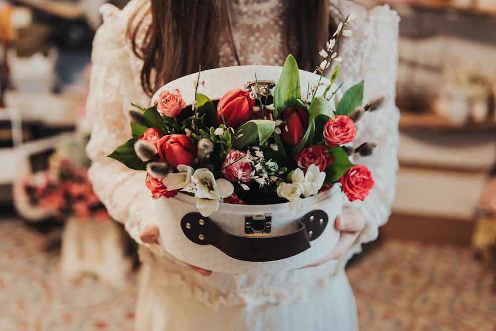 red tulips and rose flowers on box