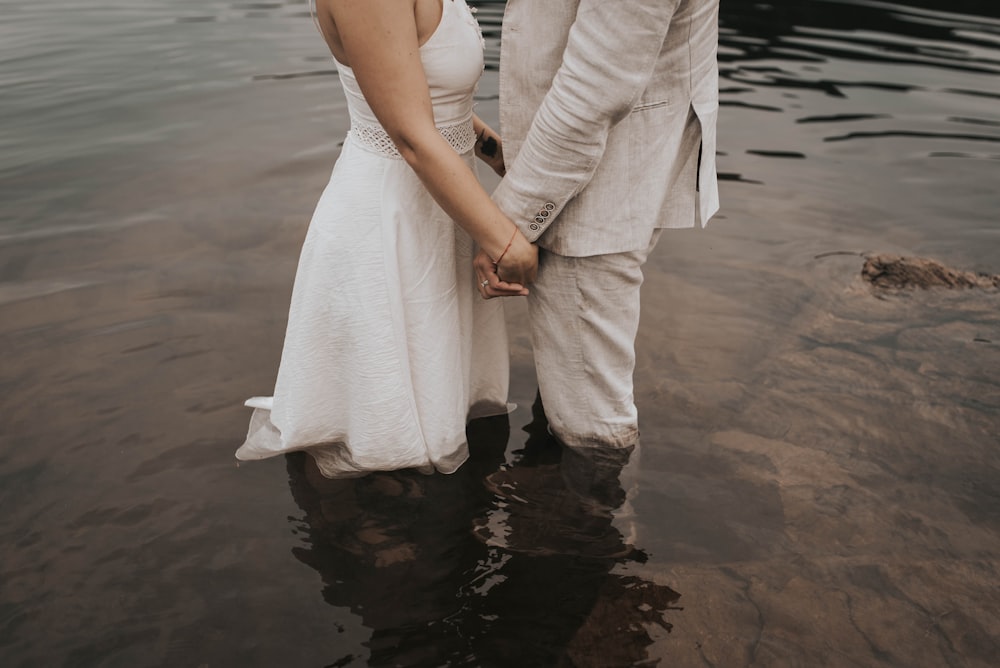 two person standing on body of water