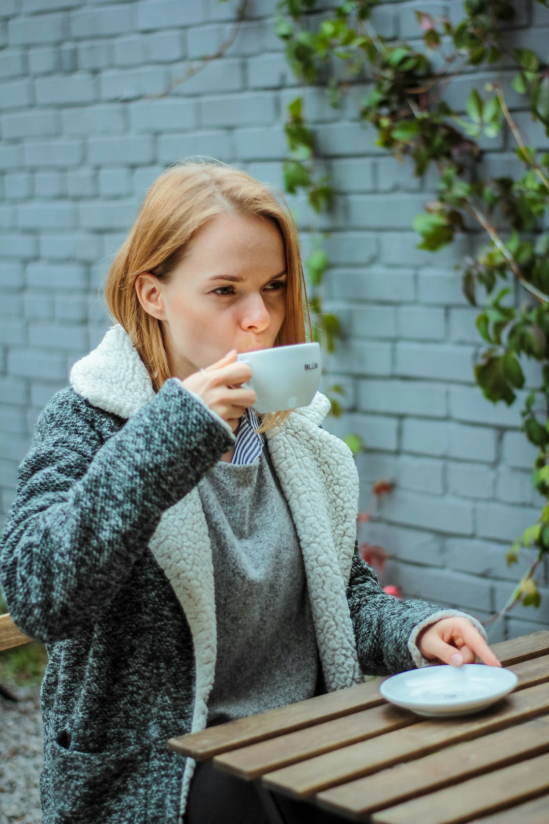 woman sipping the cup of latte