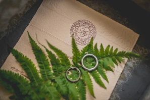 Close-up of a delicate gold-accented floral ornament on textured cream paper