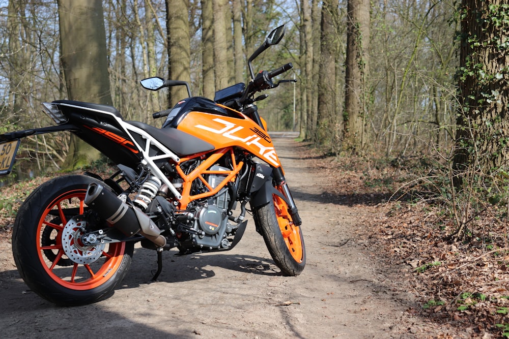 orange and black motorcycle on trail