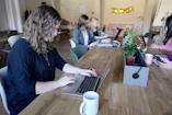 Close-up of a team coding intensely on laptops in a cozy office space.