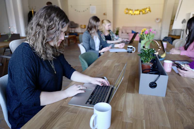 A group of diverse writers collaborating over coffee in a cozy office.