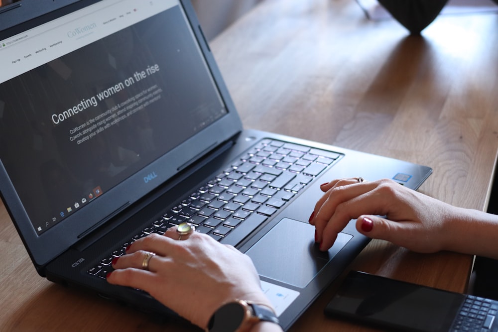 person using Dell laptop in room