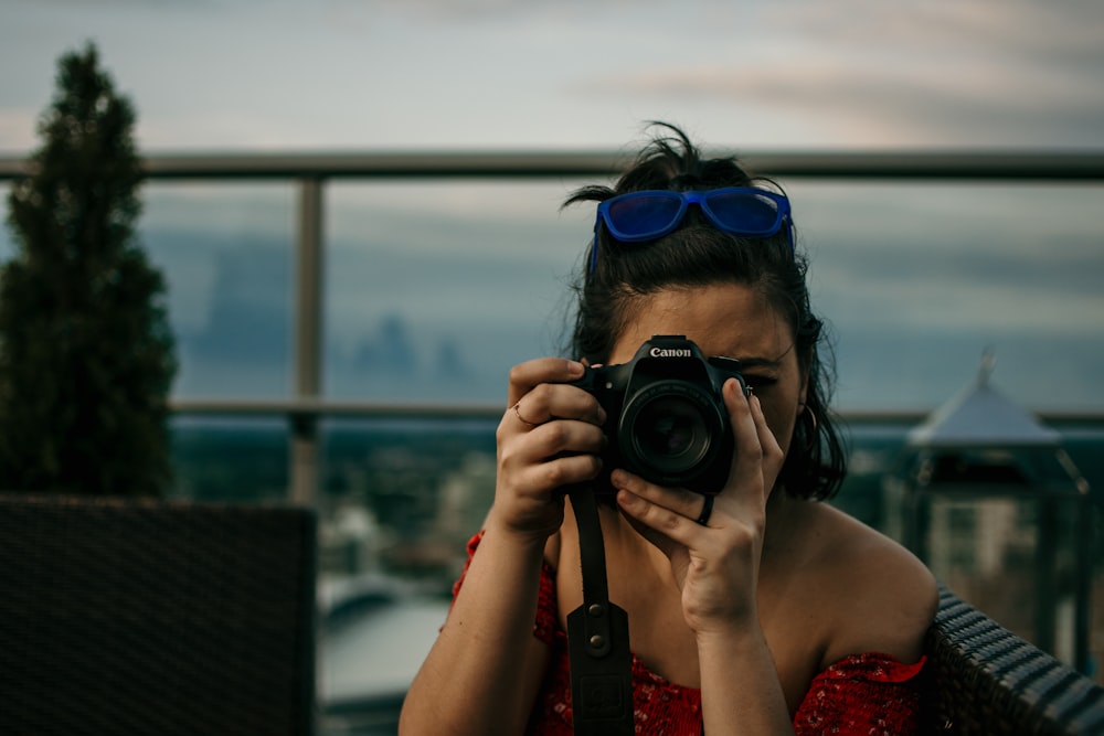 woman taking picture using a DSLR camera