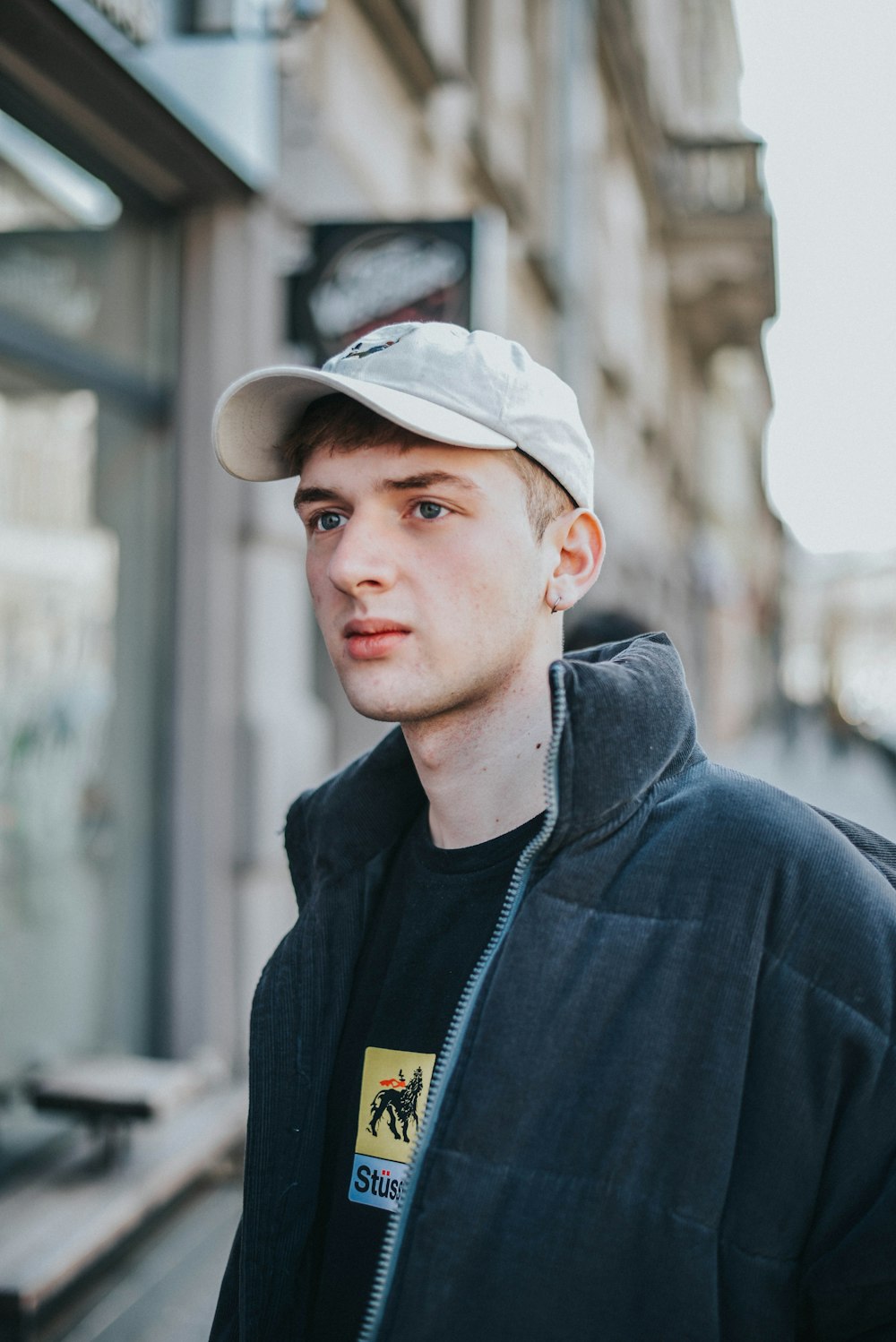 man wearing cap and black jacket