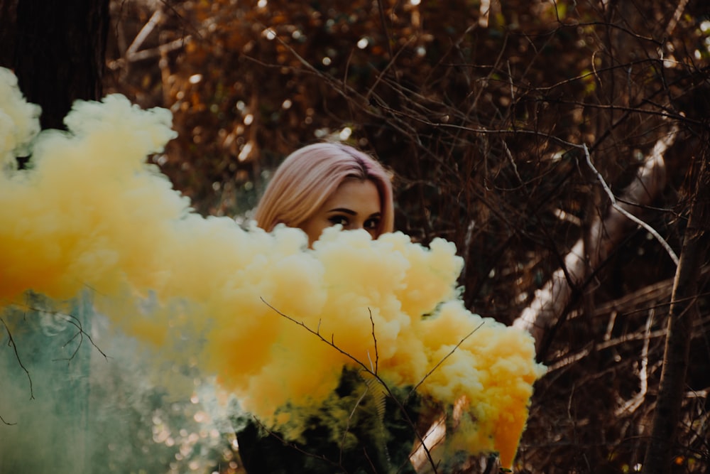 woman releasing yellow smok