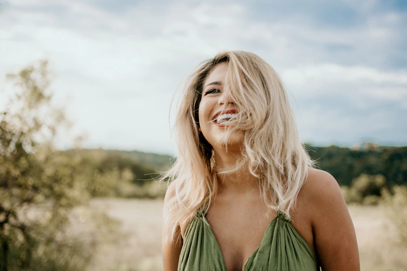 Laughing woman with hair partly covering her face