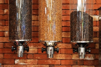 view of three varieties of coffee beans inside coffee dispensers