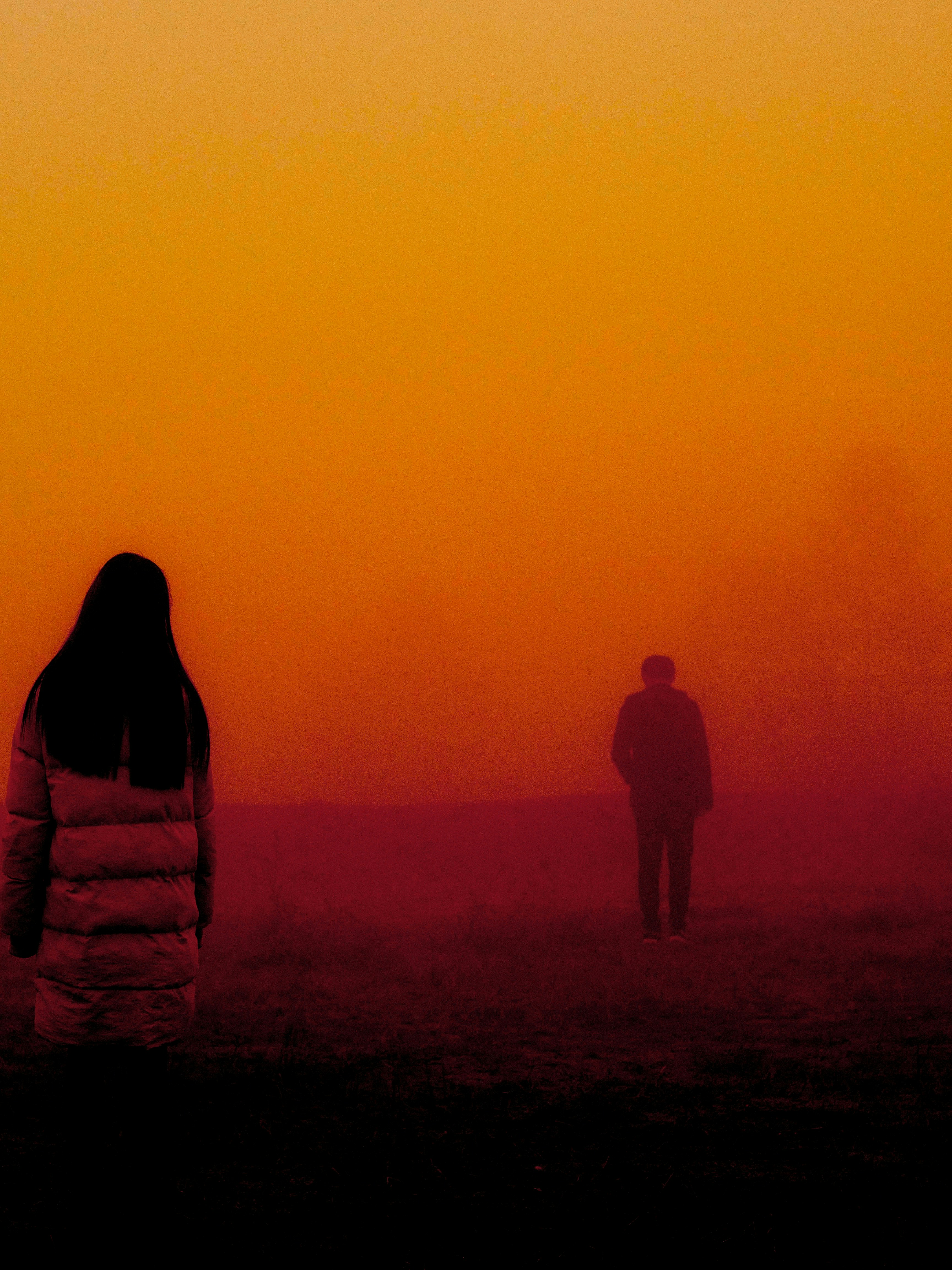 Woman wearing coat looking the boy about to walk to away