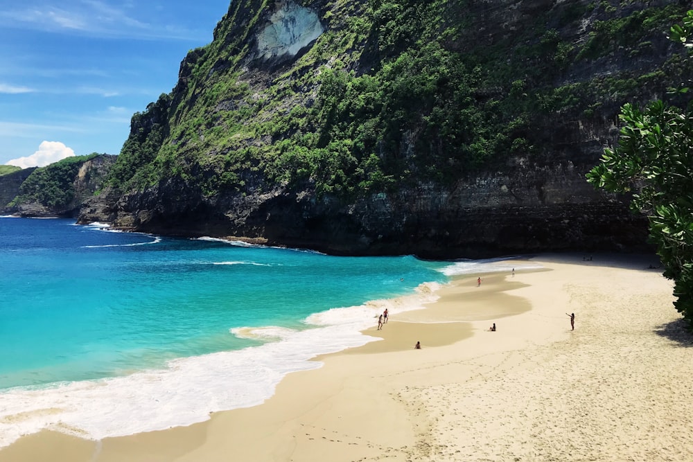 clear blue sea surrounded by rock formation