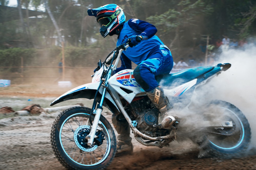 man driving white motocross dirt bike