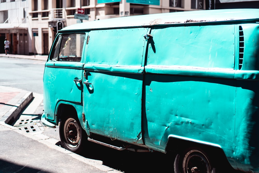 blue van parked beside road