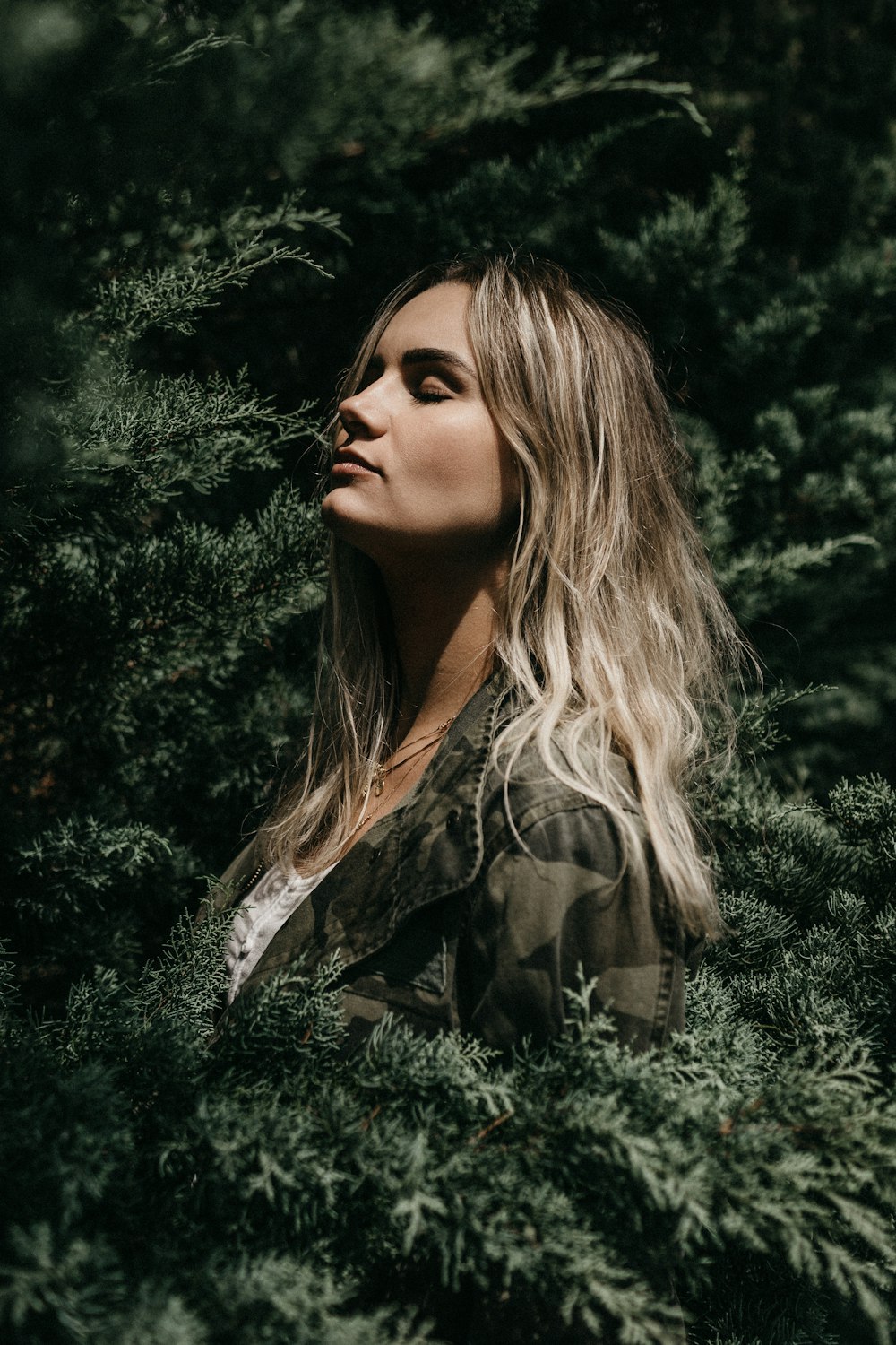 woman in woodland camouflage on trees