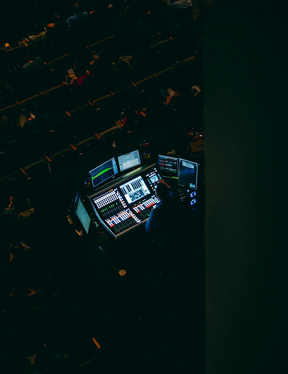 man in front of computer monitors