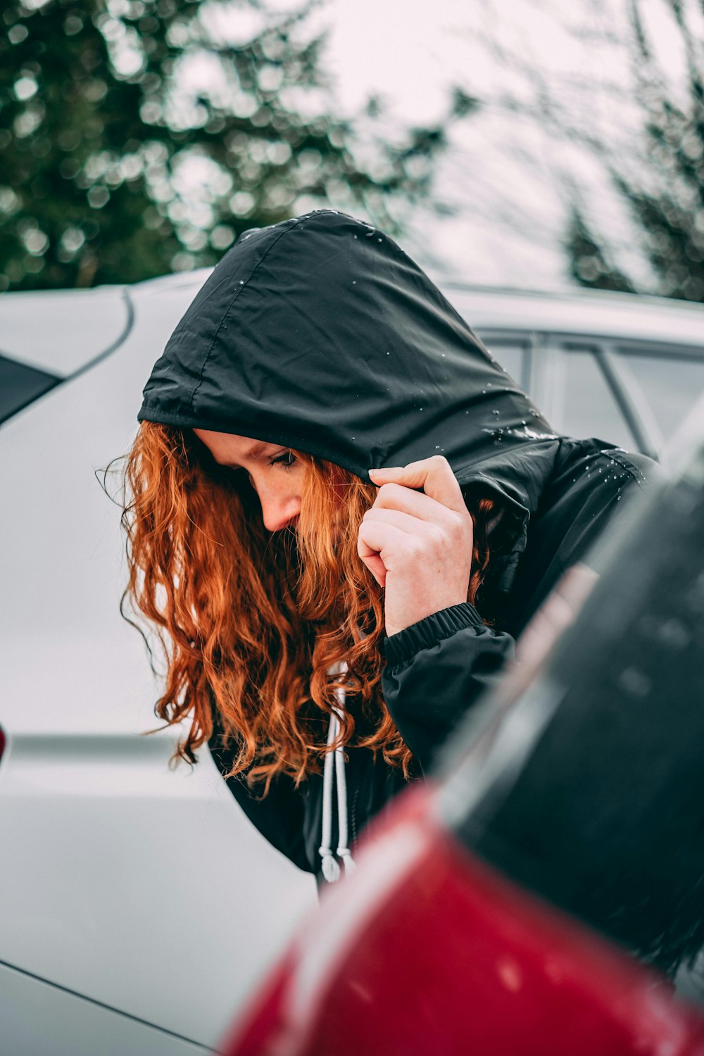 woman in hoodie near car