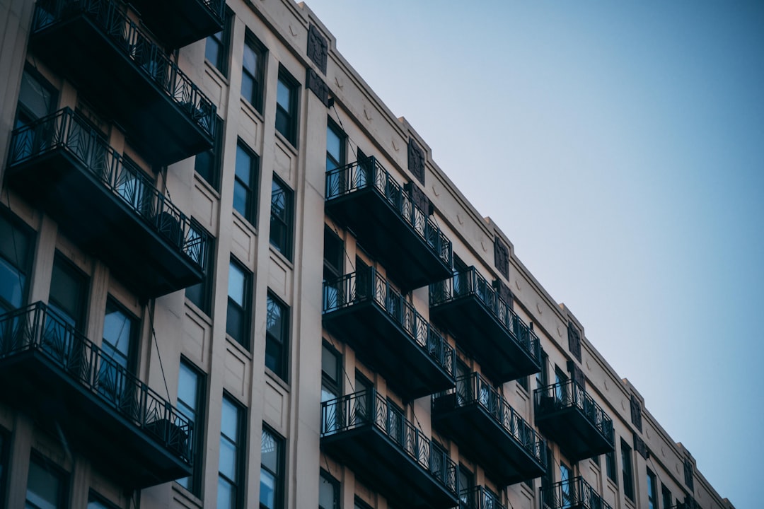 low-angle photography of brown concrete multi-story building during daytime