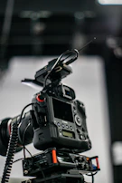 A behind-the-scenes view of a tethering station with advanced equipment and a photographer reviewing shots.