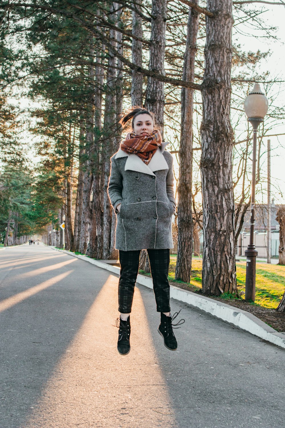 woman standing on road near trees during daytime