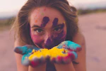 woman with coloring powders on face and hand
