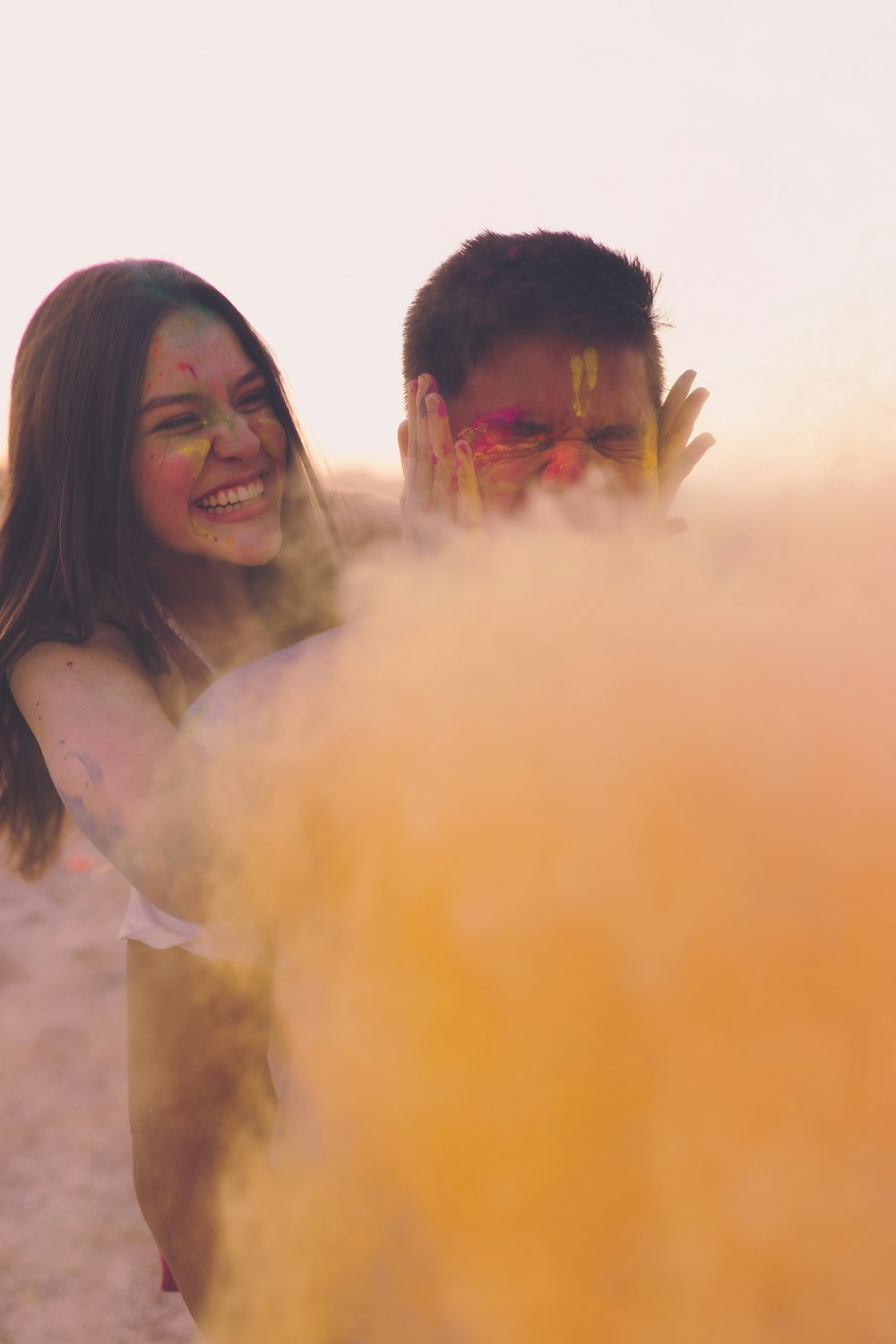 smiling woman covering man's face