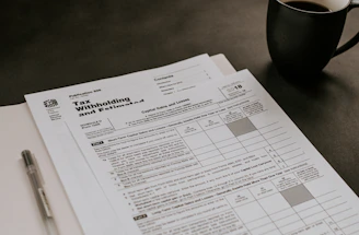 A friendly tax professional assisting a client at a bright office desk.