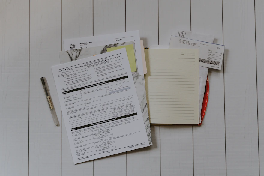 Insurance claim forms and paperwork laid out on a desk