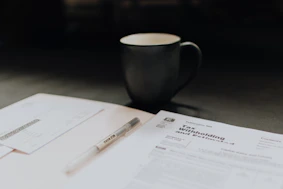 Professional auditor reviewing financial documents in a modern office.