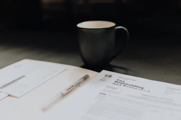 A business owner reviewing loan documents with a financial advisor in a bright office.