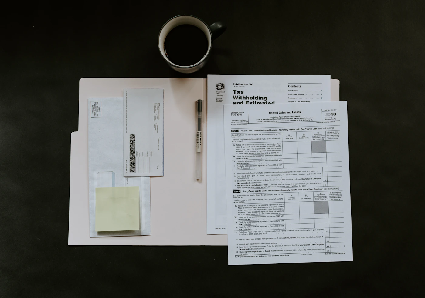 Stacks of paper documents and folders on a desk