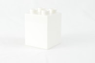 a white box with four white candles in it